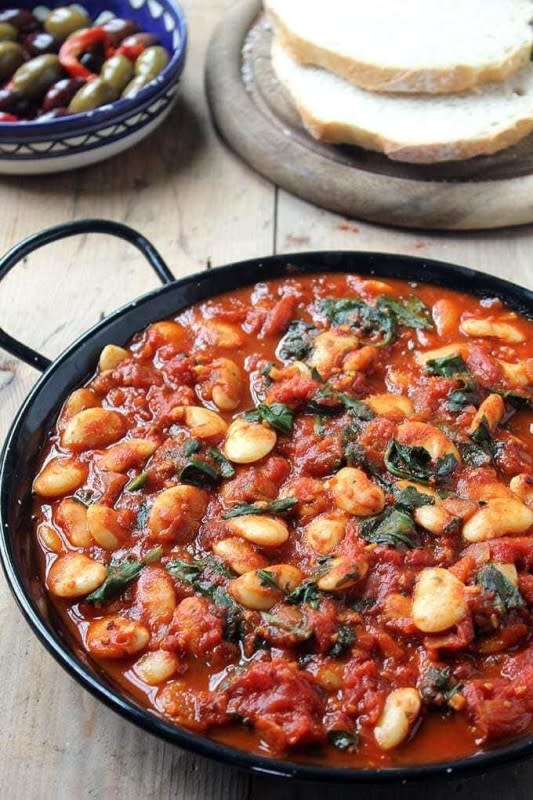 <p>Veggie Desserts</p><p>These Spanish beans with tomatoes and smokey sweet spices are so easy to prepare. You can make them in one pot in less than 20 minutes with just 7 pantry ingredients, including canned beans and tomatoes. If you don’t have fresh spinach, just use frozen.</p><p><strong>Get the Recipe: <a href="https://veggiedesserts.com/spanish-beans-tomatoes/" rel="nofollow noopener" target="_blank" data-ylk="slk:Spanish Beans with Tomatoes;elm:context_link;itc:0;sec:content-canvas" class="link ">Spanish Beans with Tomatoes</a></strong></p>