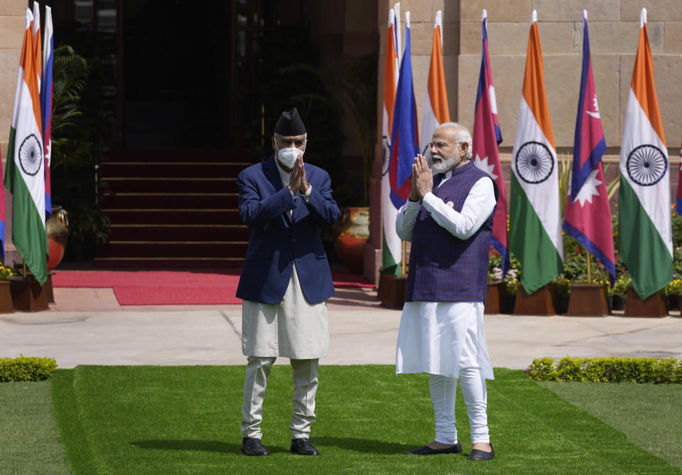 Indian Prime Minister Narendra Modi, right, greets his Nepalese counterpart Sher Bahadur Deuba before their meeting in New Delhi, India, Saturday, April 2, 2022. Deuba is on a three-day official visit to India. (AP Photo/Manish Swarup)