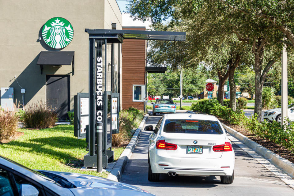 A car pulling into a Starbucks drive-thru