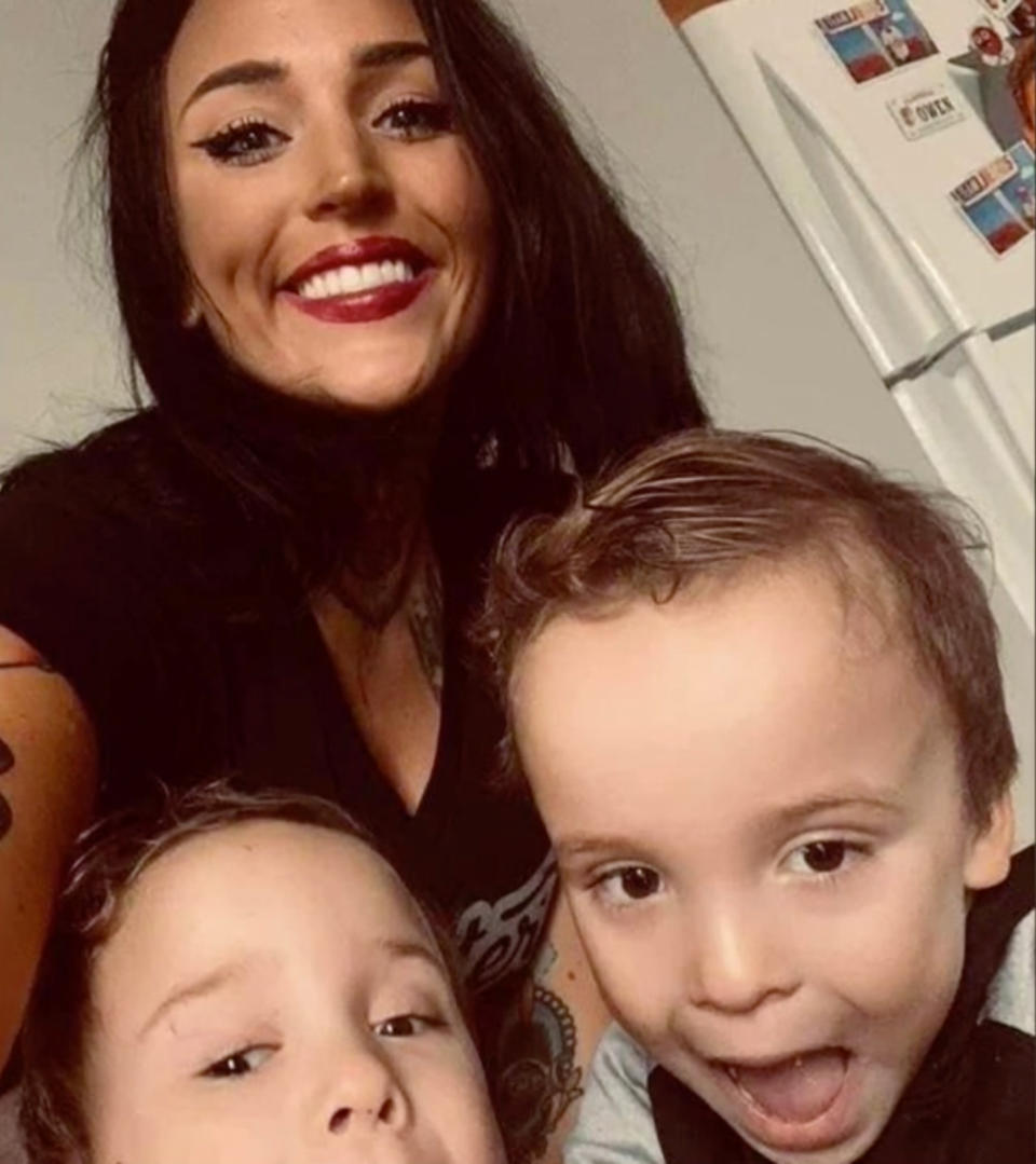 The mum and twins smiling in a selfie.