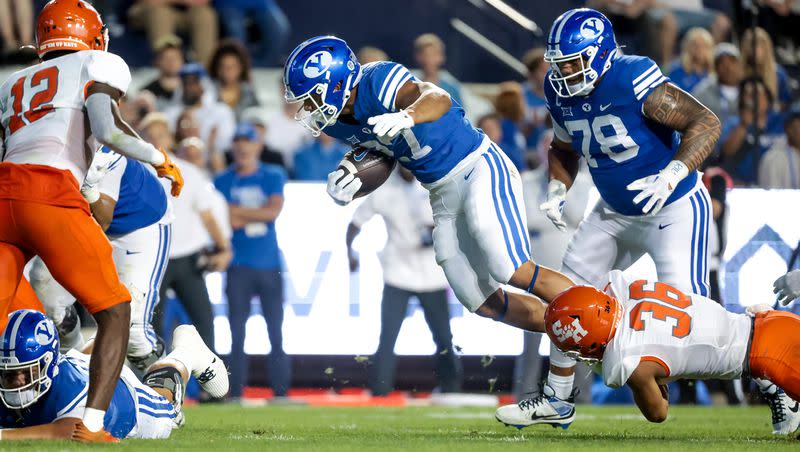 BYU running back LJ Martin is tackled by Sam Houston defensive back Elias Escobar during the game at LaVell Edwards Stadium in Provo on Saturday, Sept. 2, 2023. The true freshman made a solid first impression.