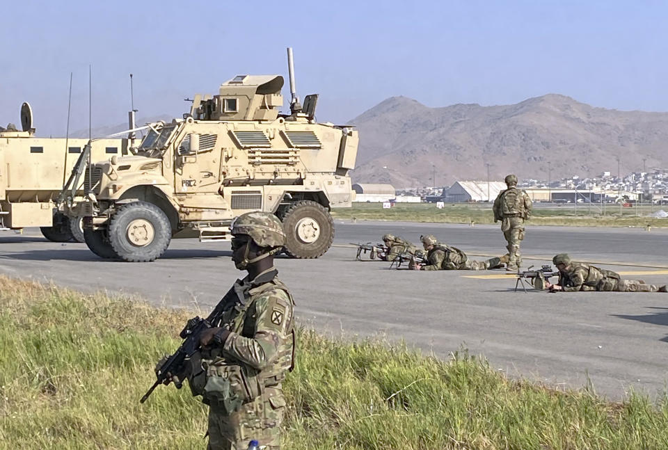 U.S soldiers stand guard along a perimeter at the international airport in Kabul, Afghanistan, Monday, Aug. 16, 2021. On Monday, the U.S. military and officials focus was on Kabul's airport, where thousands of Afghans trapped by the sudden Taliban takeover rushed the tarmac and clung to U.S. military planes deployed to fly out staffers of the U.S. Embassy, which shut down Sunday, and others. (AP Photo/Shekib Rahmani)