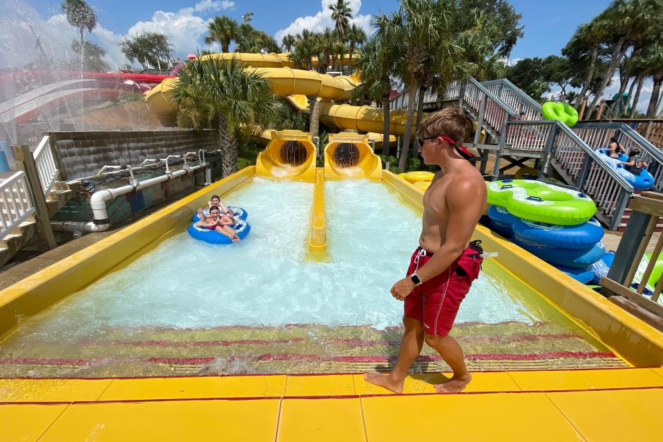 Evan Bassham with Big Kahuna's Water Park in Destin helps park visitors as they exit the Tiki River Run Wednesday afternoon. With a tight labor market and booming tourism economy, many Destin businesses are having to compete with each other for employees and are paying a highter wage than they have in the past.