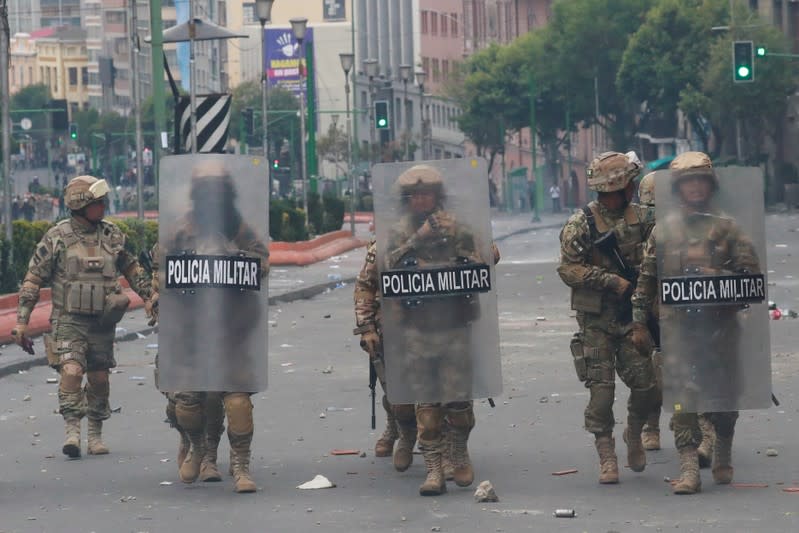 Members of the security forces walk during clashes with supporters of former Bolivian President Evo Morales in La Paz