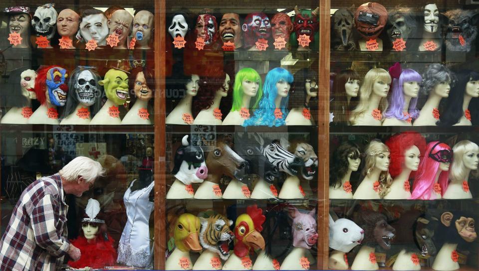 A man looks at the window of a novelty shop displaying joke masks and wigs ahead of the Halloween season in central Dublin September 25, 2013. REUTERS/Cathal McNaughton (IRELAND - Tags: SOCIETY)