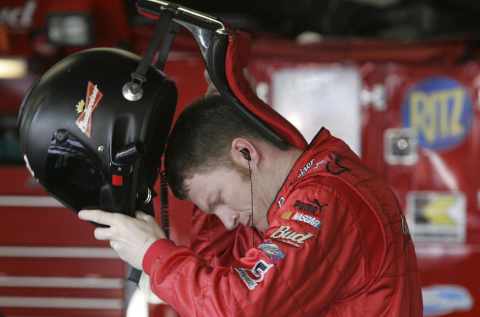 FILE - NASCAR driver Dale Earnhardt Jr., puts on his helmet and protective Hans device during preparations for the Daytona 500 auto race at Daytona International Speedway in Daytona Beach, Fla., Saturday, Feb. 18, 2006. Head-and-neck restraints and SAFER barriers. The two advancements rank as the most significant in NASCAR history. (AP Photo/Chris O'Meara, File)