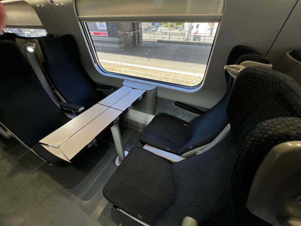 four seats around a thin table in a European train car