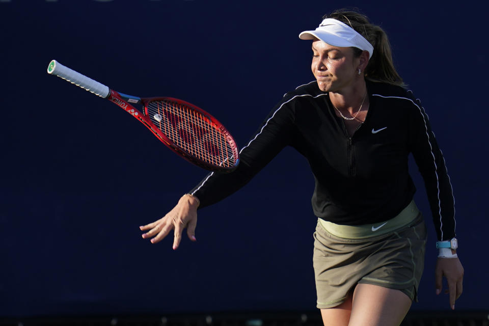 Donna Vekic, of Croatia, tosses her racket after losing a point to Iga Swiatek, of Poland, during the final match at the San Diego Open tennis tournament, Sunday, Oct. 16, 2022, in San Diego. (AP Photo/Gregory Bull)