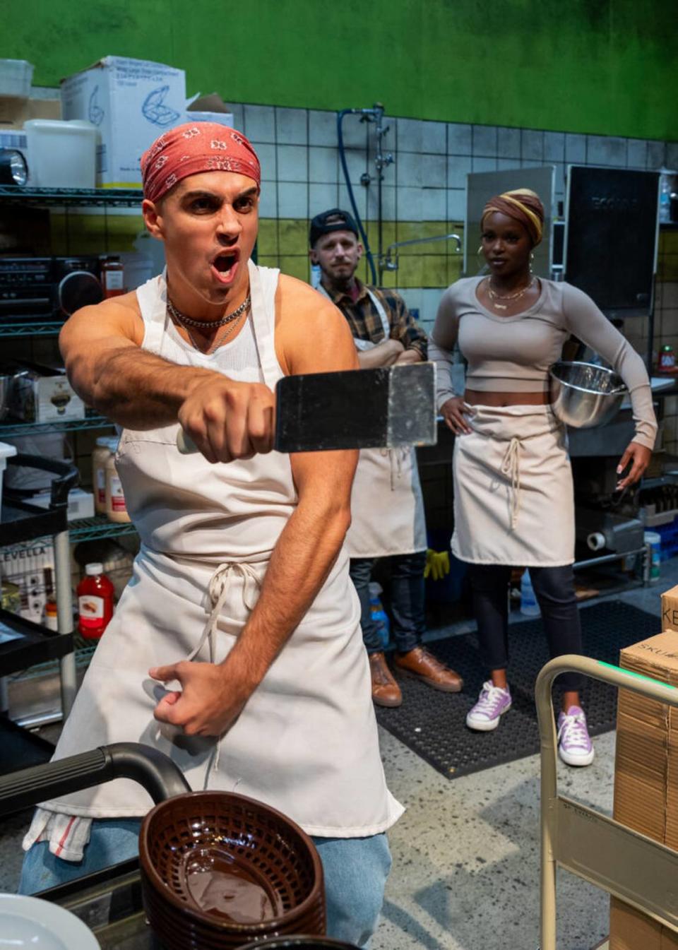From left, Gabriell Salgado shows off his grill ninja skills as Kristian Bikic and Sydney Presendieu gawk in Zoetic Stage’s production of “Clyde’s.” (Photo courtesy of Morgan Sophia Photography)