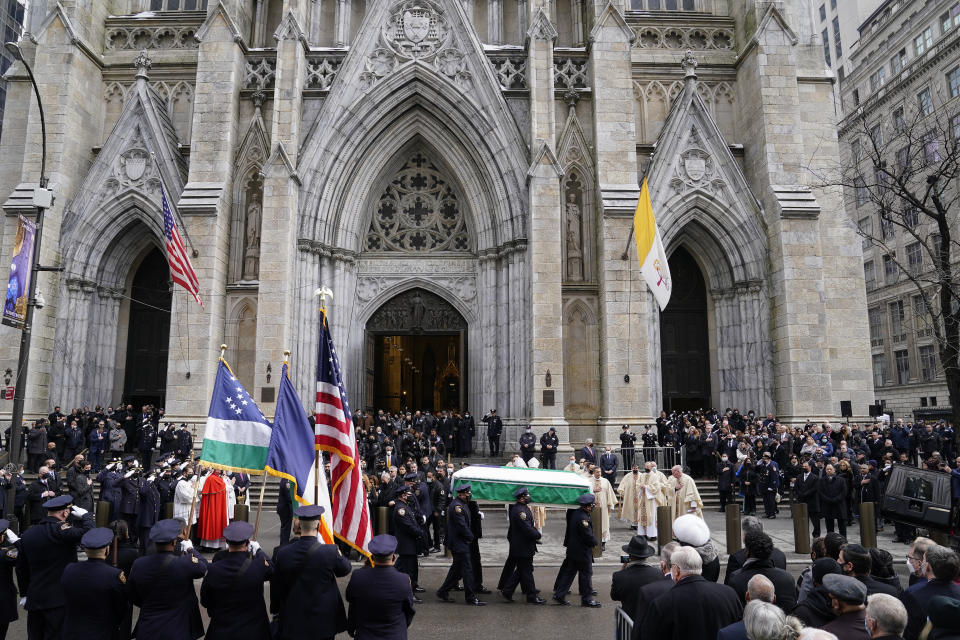 New York Police pall bearers carry the casket of Officer Wilbert Mora to a hearse following Mora's funeral service at St. Patrick's Cathedral, Wednesday, Feb. 2, 2022, in New York. For the second time in under a week, police converged on New York City's St. Patrick's Cathedral to pay tribute to a young officer gunned down while answering a call for help in Harlem. Mora was shot along with Officer Jason Rivera on Jan. 22 while responding to a call about a domestic argument in an apartment. (AP Photo/John Minchillo)