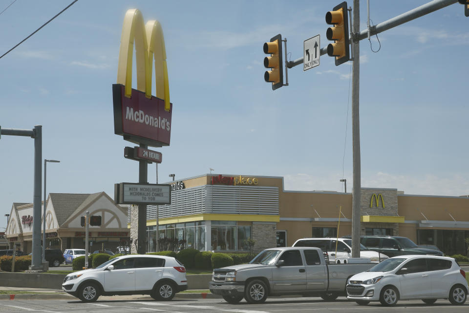 Cars drive by a McDonald's restaurant Thursday, May 7, 2020, in Oklahoma City, where three McDonald's employees suffered gunshot wounds when a customer opened fire because she was angry that the restaurant's dining area was closed because of the coronavirus pandemic, on Wednesday. (AP Photo/Sue Ogrocki)