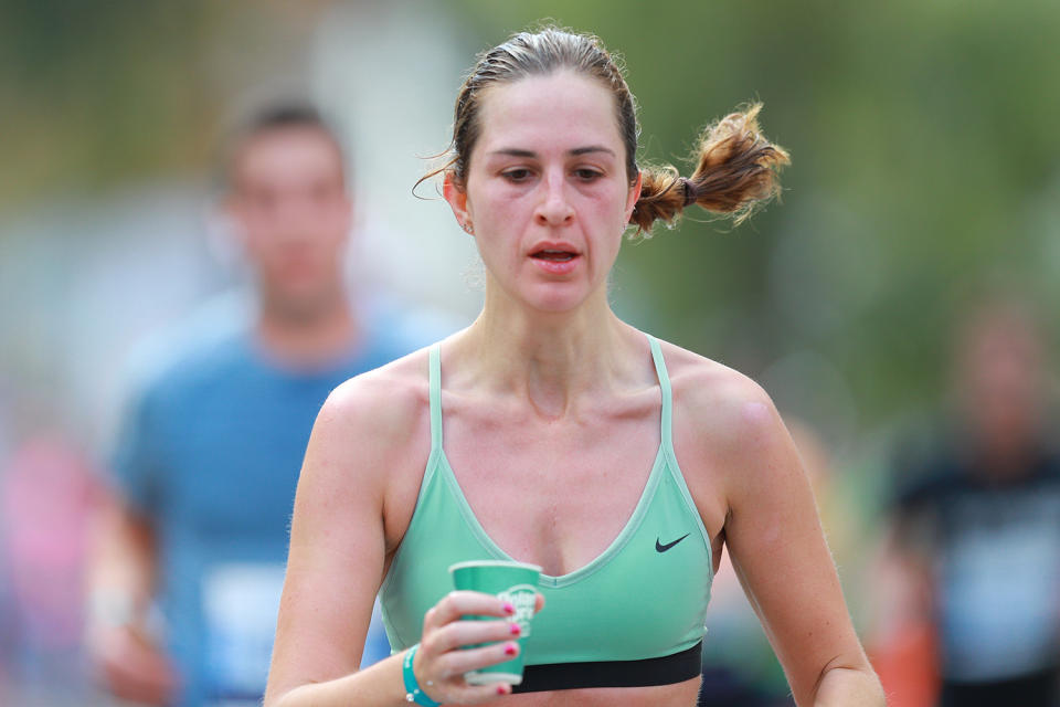 A runner grabs water during the 2019 New York City Marathon. (Photo: Gordon Donovan/Yahoo News)