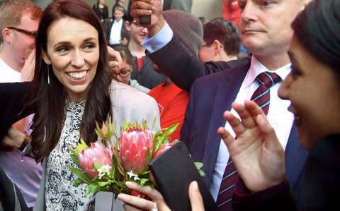 Jacinda Ardern is mobbed by university students during a visit to Victoria University in Wellington on September 19 - Credit: MARTY MELVILLE/AFP