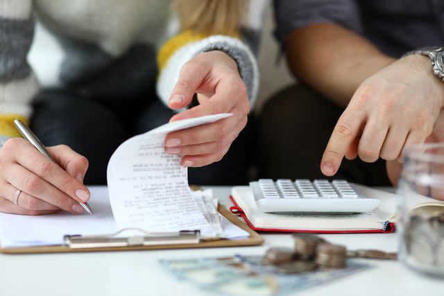 <p>Getty</p> A stock image of a man and woman working on finances