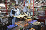 Afghans read books in a specialized religious bookstore in Kabul, Afghanistan, Tuesday, April 23, 2024. (AP Photo/Siddiqullah Alizai)