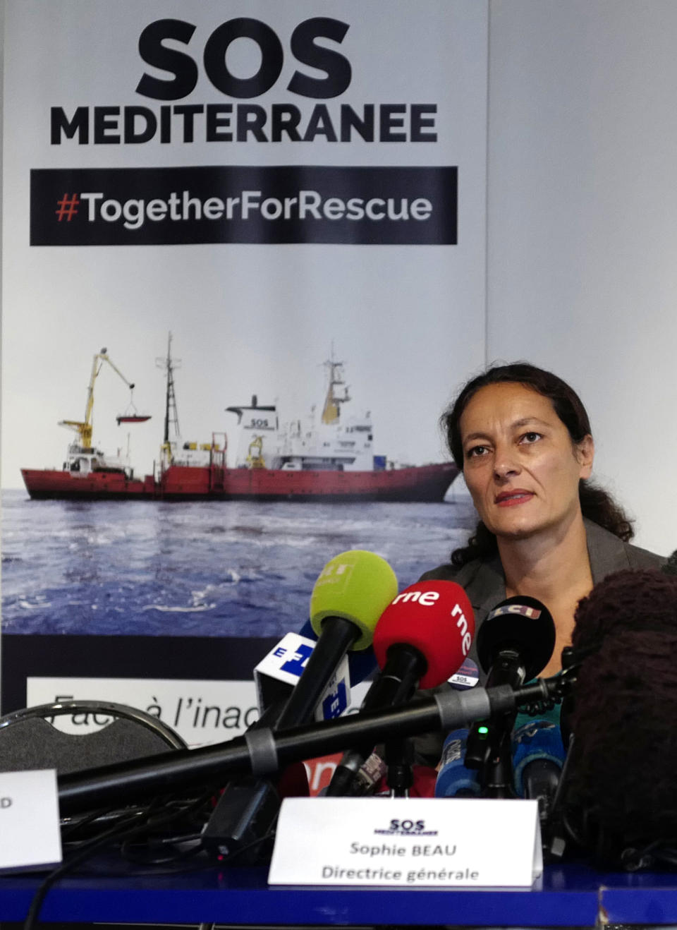 Sophie Beau, left, general director of SOS Mediterranee France, answer reporters Tuesday, Aug.14, 2018 in Paris. Portugal has become the first European country to say it could take in some migrants aboard rescue ship Aquarius, operated by French groups, as officials in coastal France made impassioned pleas to a so-far-silent French government to allow its docking. (AP Photo/Michel Spingler)