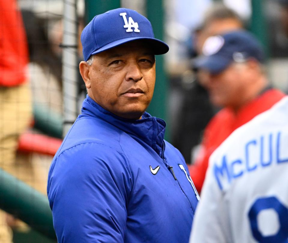 Dave Roberts in the dugout before the Dodgers' game in Washington on Tuesday.