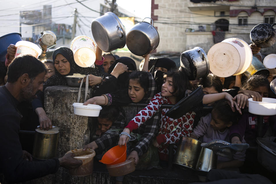 Palestinians line up for a free meal in Rafah, Gaza Strip, on Tuesday, March 12, 2024. (AP Photo/Fatima Shbair)