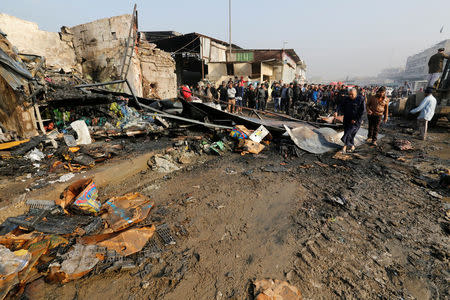 People gather at the site of a car bomb attack at a vegetable market in eastern Baghdad, Iraq January 8, 2017. REUTERS/Wissm al-Okili