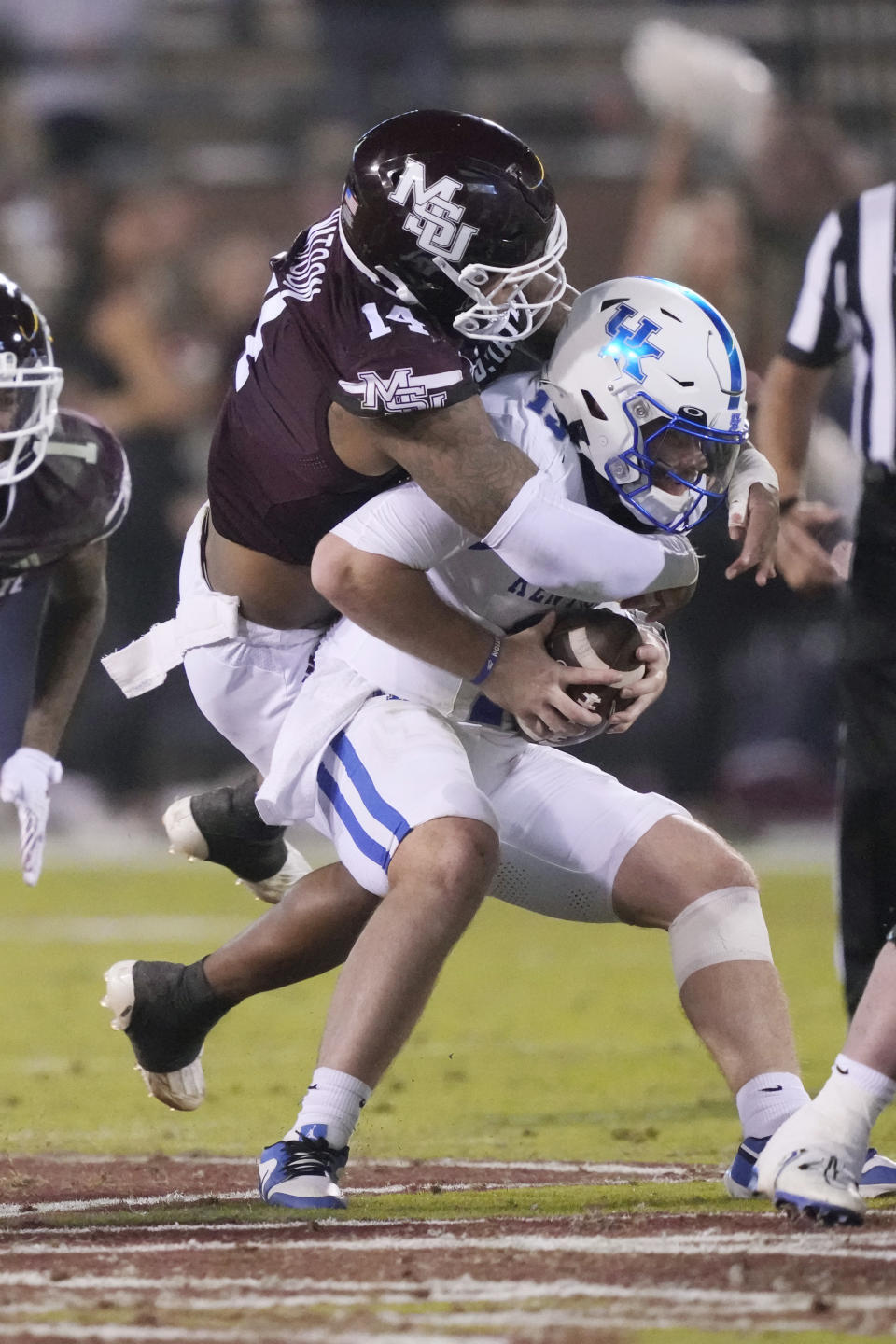 Mississippi State linebacker Nathaniel Watson (14) sacks Kentucky quarterback Devin Leary (13) during the second half of an NCAA college football game in Starkville, Miss., Saturday, Nov. 4, 2023. (AP Photo/Rogelio V. Solis)