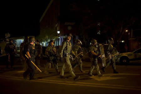 Police are seen along Pennsylvania Avenue two days after it was looted and set ablaze in protest against the death of Freddie Gray, a 25-year-old black man who died in police custody, in Baltimore, Maryland April 29, 2015. REUTERS/Eric Thayer