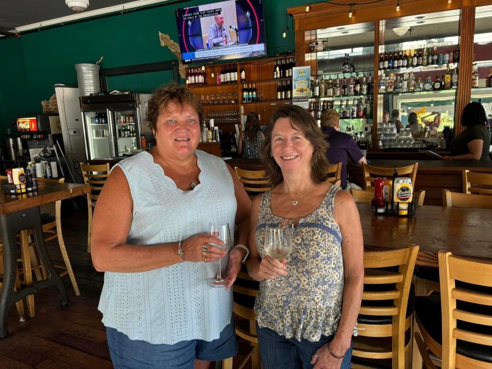 Dinwiddie residents Sheila Olsen and her friend Charlene relax inside Longstreet's Deli in Petersburg during a heat wave.