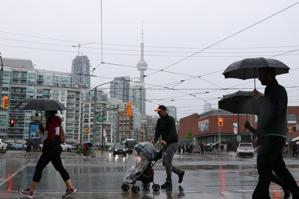 People crossing a zebra crossing on a rainy day in Toronto, Ontario, Canada on May 25, 2024. (Photo by Arrush Chopra/NurPhoto via Getty Images)