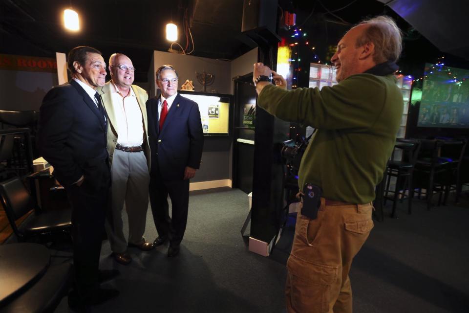 Actor, comedian and radio host Joe Piscopo, left, and New Jersey Assembly Republican Leader Jon Bramnick, right, R-Union, N.J., have their photograph taken with a fan during a comedy event to help raise funds for the Boys and Girls Club of America at the Stress Factory Comedy Club Tuesday, Dec. 6, 2016, in New Brunswick, N.J. Piscopo is serious when he says he's considering a run for New Jersey governor in 2017. He says he's been meeting with Republican county officials and lawmakers to feel out his prospects. (AP Photo/Mel Evans)