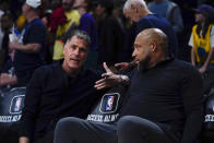 Los Angeles Lakers general manager Rob Pelinka, left, and head coach Darvin Ham speak before an NBA basketball game against the Golden State Warriors, Tuesday, April 9, 2024, in Los Angeles. (AP Photo/Ryan Sun)
