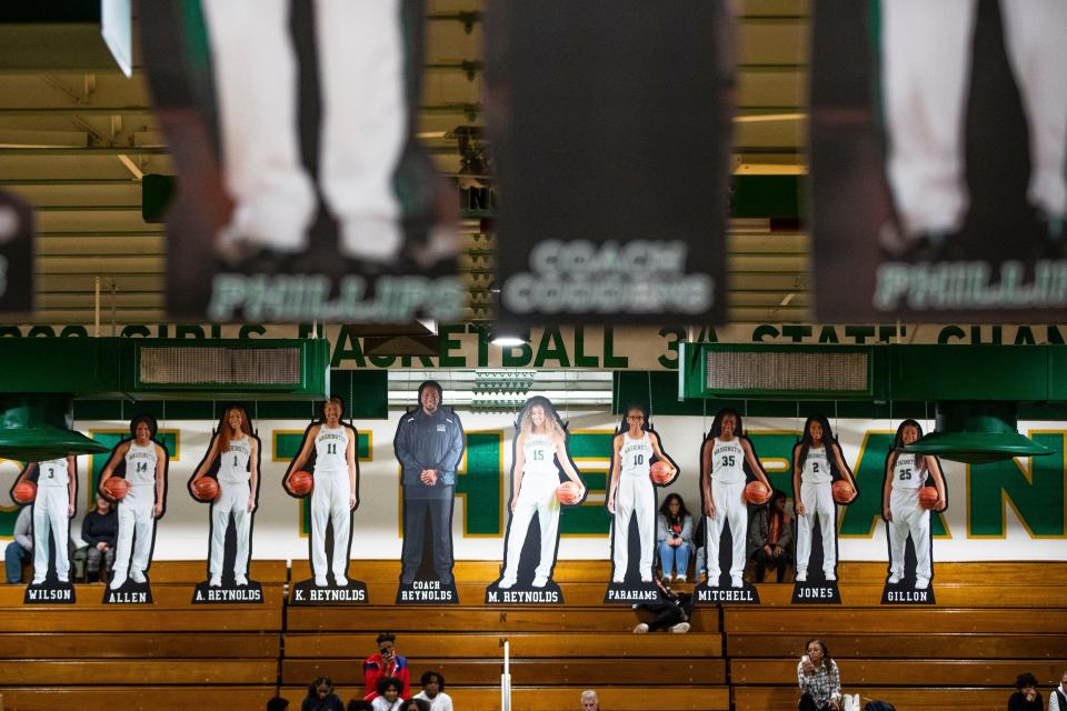 The 2021-22 state championship-winning Washington girls basketball team cutouts hang from the rafters before the Washington vs. Riley girls basketball game Tuesday, Nov. 15, 2022 at Washington High School.