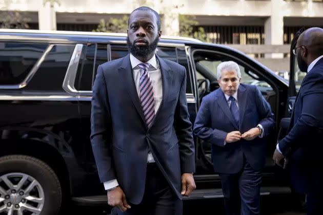 Prakazrel “Pras” Michel, center, a member of the 1990s hip-hop group the Fugees, arrives at federal court for his trial in an alleged campaign finance conspiracy on March 30 in Washington.