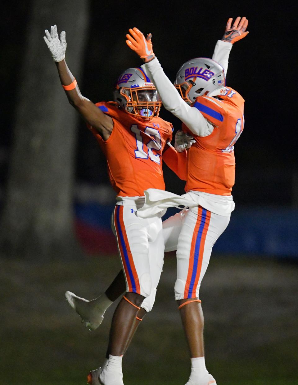 Bolles Bulldogs' Naeem Burroughs (12) celebrates with teammate Bolles Bulldogs' Chase Collier (15) after Burroughs' late second quarter catch for a touchdown. The Buchholz Bobcats traveled from Gainesville to play The Bolles School Bulldogs at Skinner-Barco Stadium in Jacksonville, FL Friday November 4, 2022.