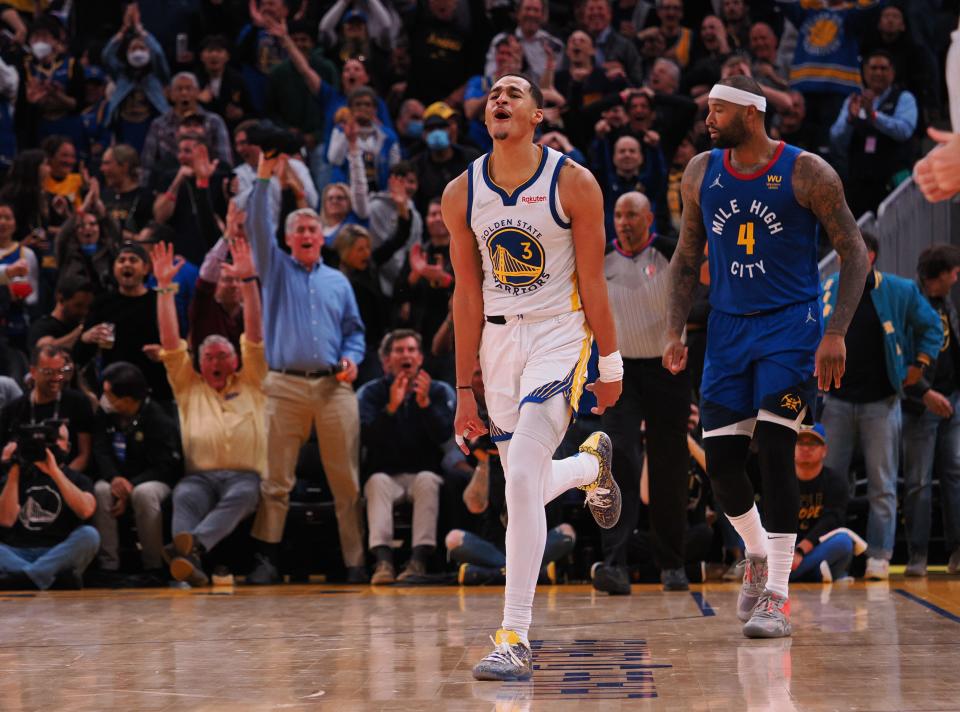 Golden State Warriors guard Jordan Poole (3) reacts after scoring a basket against Denver Nuggets center DeMarcus Cousins (4) during the third quarter of game two of the first round for the 2022 NBA playoffs at Chase Center.