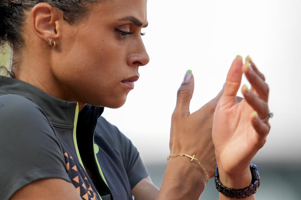 Sydney McLaughlin-Levrone prepares for the start of the women's 400-meter hurdles final during the U.S. Track and Field Olympic Team Trials, Sunday, June 30, 2024, in Eugene, Ore. It’s been 100 years since a Scottish runner famously refused to race on a Sunday at the Paris Olympics because of his Christian beliefs. American Olympic champion Sydney McLaughlin-Levrone, who broke her own world record at Olympic trials Sunday in the 400-meter hurdles, describes how Eric Liddell’s words about running to glorify God resonated with her in her new book, “Far Beyond Gold.” (AP Photo/George Walker IV)