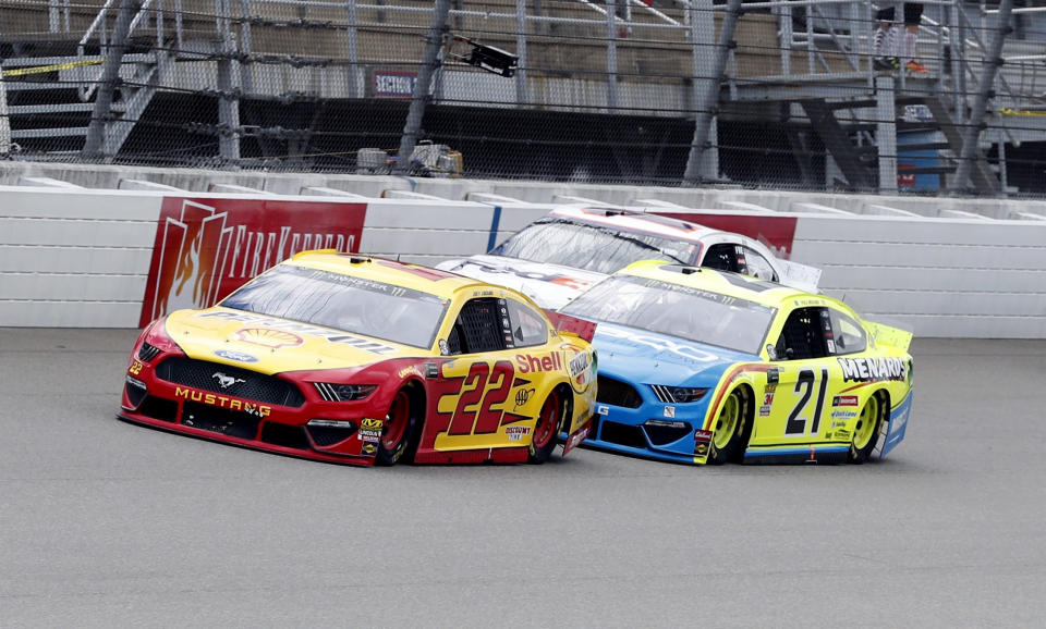 Joey Logano (22) leads Paul Menard (21) and Denny Hamlin (11) at a NASCAR Cup Series auto race at Michigan International Speedway, Monday, June 10, 2019, in Brooklyn, Mich. (AP Photo/Carlos Osorio)