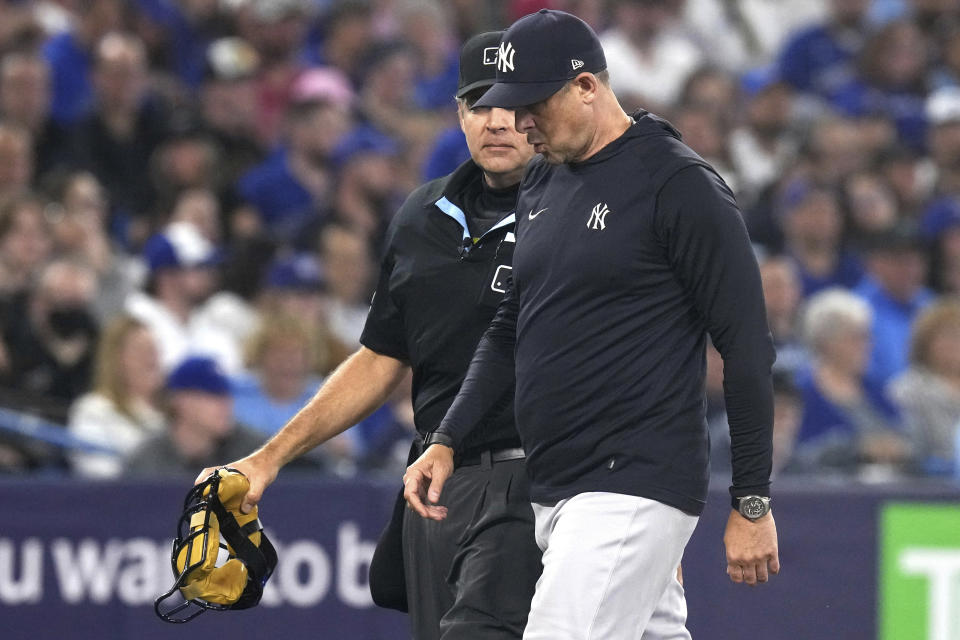 New York Yankees Manager Aaron Boone, right, talks with umpire James Hoye after Yankees pitcher Domingo German was ejected during the fourth inning of the team's baseball game against the Toronto Blue Jays on Tuesday, May 16, 2023, in Toronto. (Chris Young/The Canadian Press via AP)
