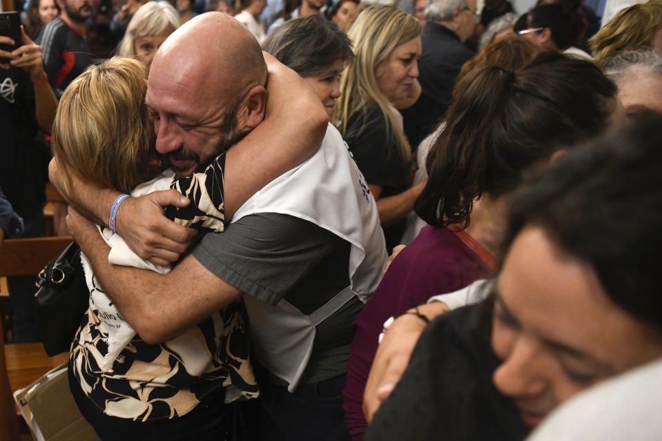 Relatives of victims embrace after the reading of the verdict for former police officers on trial for crimes against humanity during the 1976-1983 dictatorship, in La Plata, Argentina, Tuesday, March 26, 2024. The officers were convicted on Tuesday of torturing over 20 pregnant women and stealing at least 10 babies, seven of which have been identified and recovered. Hundreds of babies were abducted during the Argentine dictatorship. (AP Photo/Gustavo Garello)