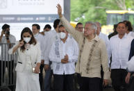 Mexican President Andres Manuel Lopez Obrador waves to supporters in Lazaro Cardenas, Quintana Roo state, Mexico, Monday, June 1, 2020. Amid a pandemic and the remnants of a tropical storm, President Lopez Obrador kicked off Mexico's return to a "new normal" Monday with his first road trip in two months as the nation began to gradually ease some virus-inspired restrictions. (AP Photo/Victor Ruiz)