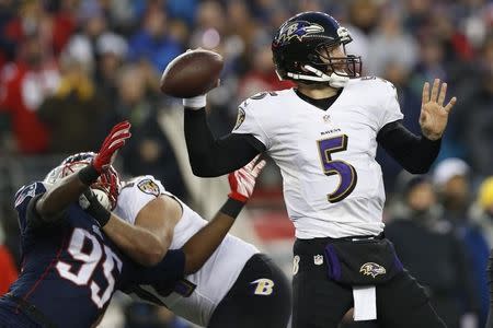 Jan 10, 2015; Foxborough, MA, USA; Baltimore Ravens quarterback Joe Flacco (5) throws the ball in front of New England Patriots defensive end Chandler Jones (95) in the first quarter during the 2014 AFC Divisional playoff football game at Gillette Stadium. Mandatory Credit: Greg M. Cooper-USA TODAY Sports