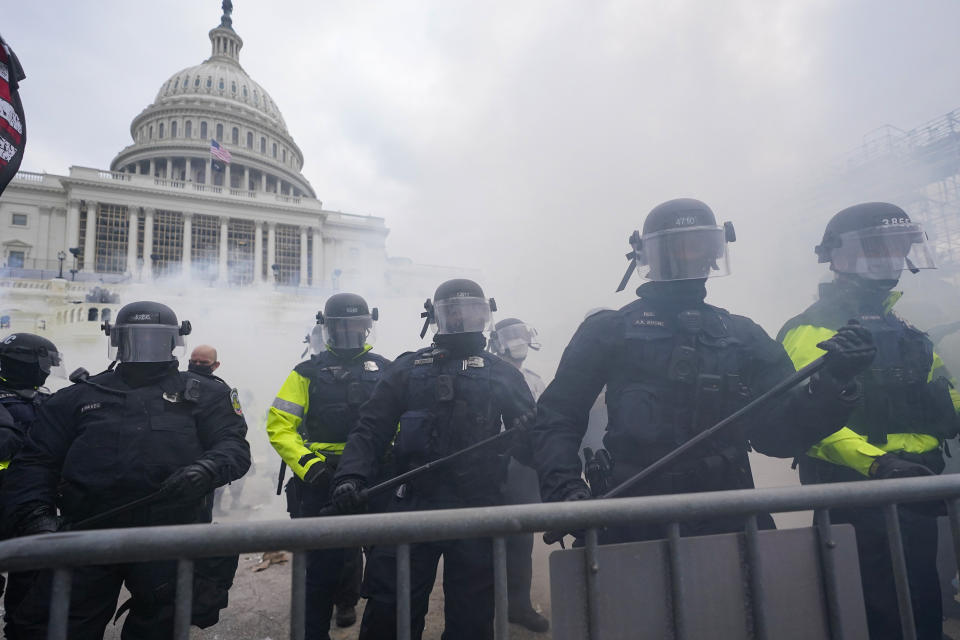 U.S, Capitol Police officers along with Washington Metropolitan Police Department officers stand on the West Front of the U.S. Capitol on Jan. 6, 2021, in Washington. (AP Photo/Julio Cortez)