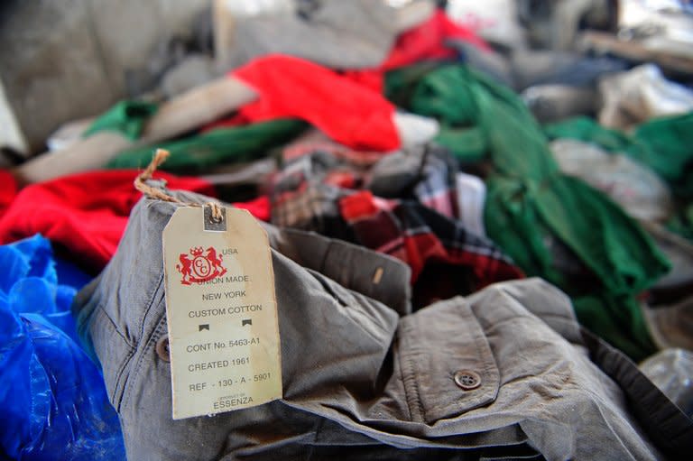 Items of clothing lie in the rubble of a collapsed garment factory in Savar, on the outskirts of Dhaka, on May 2, 2013. International workers' associations such as Swiss-based UNI and IndustriALL Global Union have pressured Western retailers to sign up to a legally binding agreement committing them to independent building and fire safety inspections