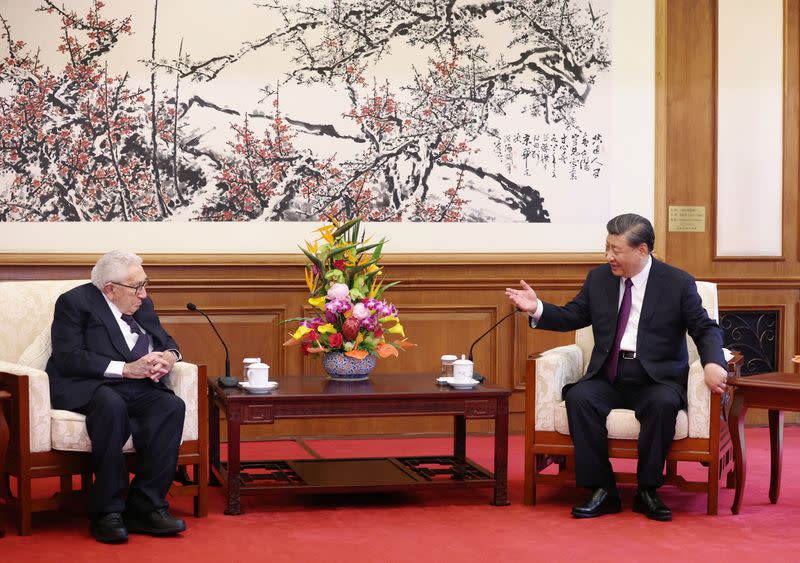 Chinese President Xi Jinping and Henry Kissinger, former U.S. secretary of state, attend a meeting in Beijing