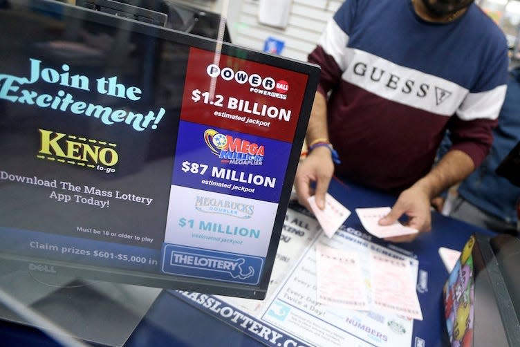 A convenience store owner places Powerball tickets on November 1, 2022 in Quincy, Massachusetts, in an image used for illustration only.