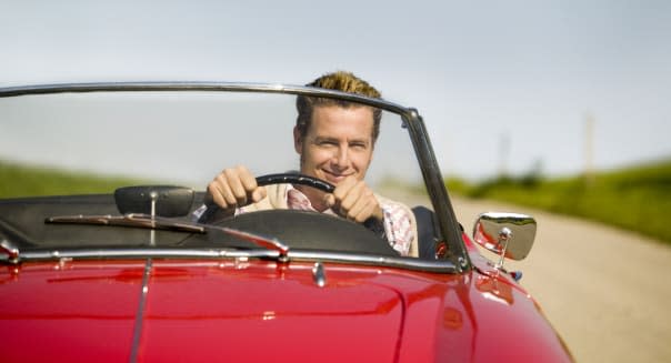 Man driving convertible in countryside