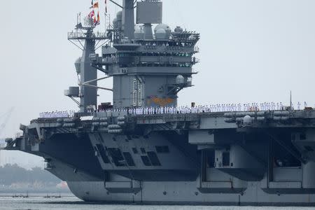 FILE PHOTO: Sailors man the rails as aircraft carrier USS Nimitz with Carrier Strike Group 11, and some 7,500 sailors and airmen depart for a 6 month deployment in the Western Pacific from San Diego, California, U.S., June 5, 2017. REUTERS/Mike Blake