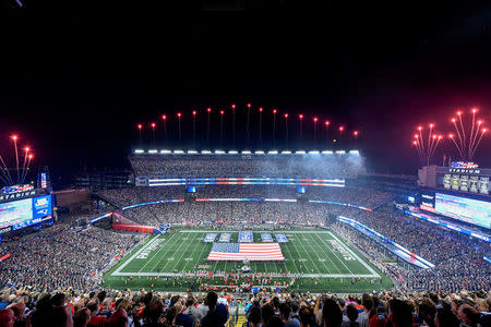 FILE PHOTO: A U.S. flag is displayed at Gillette Stadium before a game between the New England Patriots and the Kansas City Chiefs in Foxborough, Massachusetts, U.S. on September 7, 2017. REUTERS/Brian Fluharty/USA TODAY Sports/File Photo