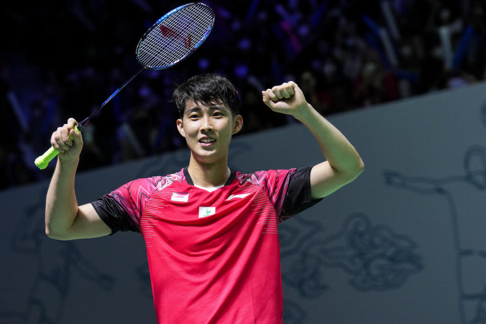 Singapore shuttler Loh Kean Yew raises his arms in victory at the Indonesia Open. (Photo by Shi Tang/Getty Images)