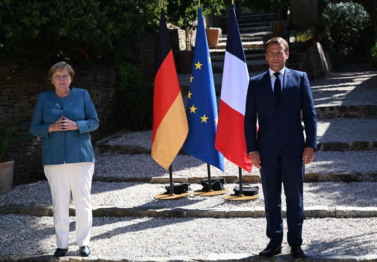 French President Emmanuel Macron (R) and German Chancellor Angela Merkel. Both nations have seen a sharp rise in coronavirus cases in recent weeks. (Getty)