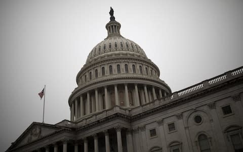 An American flag flies outside of the U.S. Capitol in Washington, DC - Credit: Aaron P. Bernstein/Bloomberg