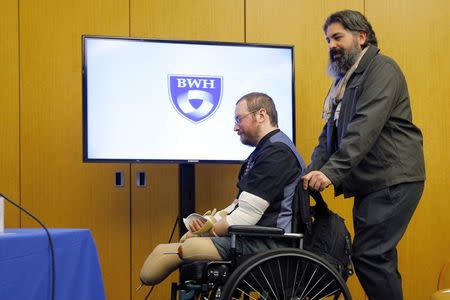 Will Lautzenheiser (L), accompanied by his partner Angel Gonzalez (R), arrives at a news conference to announce his successful double arm transplant at Brigham and Women's Hospital in Boston, Massachusetts November 25, 2014. REUTERS/Brian Snyder